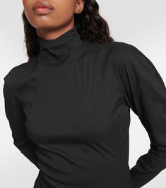 High-neck top in black - Alaia | Mytheresa Elegant High Stretch Tops With Thumbholes, Elegant Stretch Top With Funnel Neck, Elegant Stretch Funnel Neck Top, Chic High-neck Tops With Thumbholes, Elegant Funnel Neck Stretch Top, Black Second-skin Tops For Workwear, Evening Top With Fitted Elastic Shoulders, High Neck Elastane Tops With High Stretch, Evening Tops With Elastic Shoulders And Fitted Style