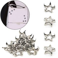 several metal stars are shown next to a white card and some other silver colored objects