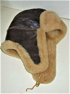 Vintage 2 -3 plus Year old Sheep Skin Hunters Earflap Hat in very nice used condition. Size SMALL Womens sz. Hard to measure accurately. Item has normal age and use wear. Hardly worn Please look at pictures and ask any questions. Item sold as used and as-is. Please view our other items. Brown Windproof Beanie Hat, Adjustable Windproof Aviator Hat, Adjustable Brown Hat With Fleece Lining, Brown Fleece-lined Cap, Brown Outdoor Hats With Fleece Lining, Adjustable Brown Hats With Faux Fur Lining, Brown Cap With Fleece Lining, Adjustable Faux Fur Lined Hat With Ear Flaps, Brown Winter Hats