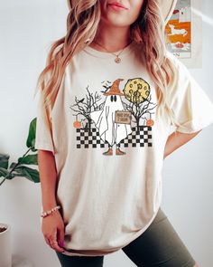 Looking for a comfortable, cute fall shirt that will make you stand out from the crowd? Look no further than our Comfort Colors Funny Ghost t-shirt! Give it as a gift to your friends and family this fall season, or wear it yourself to show your support for all things Halloween. Comes in multiple colors! Check out more designs here: www.etsy.com/shop/jadeandroseshop ✨️SIZE AND FIT: Your shirt will be printed on a high-quality, soft and comfortable unisex t-shirt. Sizes run true to size, which tak Casual Fall Shirt With Cartoon Print, Fall Cotton Shirt With Cartoon Print, Casual Fall T-shirt With Cartoon Print, Cute Pre-shrunk Shirt For Fall, Spooky Short Sleeve T-shirt For Fall, Spooky Cartoon Print T-shirt For Fall, Fall Spooky Cartoon Print T-shirt, Casual Cotton Halloween Shirt, White Tops With Character Print For Fall