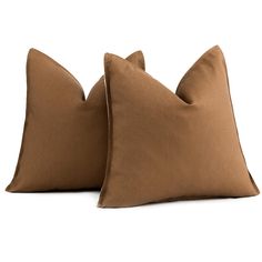 two brown pillows sitting on top of each other