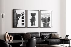 three black and white pictures hang on the wall above a couch in a living room