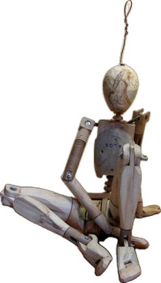 a wooden robot hanging from a string