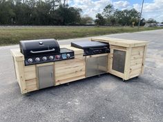 an outdoor kitchen made out of pallet wood with grill and sink on the side