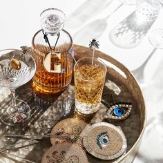 an assortment of glassware on a tray