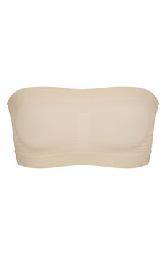 Designed to disappear under clothes, this strapless bandeau from Kim Kardashian's SKIMS supports and defines your bust while smoothing your back. Removable, adjustable straps 82% nylon, 18% spandex Machine wash, tumble dry Made in Turkey Strapless Nylon Tube Top With Built-in Bra, Strapless Sculpting Shapewear With Medium Bust Support, Strapless Shapewear With Built-in Bra, Smoothing Bandeau Solid Tube Top, Solid Smoothing Bandeau Tube Top, Fitted Strapless Tube Top With Medium Bust Support, Smoothing Solid Bandeau Tube Top, Stretch Bandeau Shapewear With Built-in Bra, Stretch Bandeau Tube Top