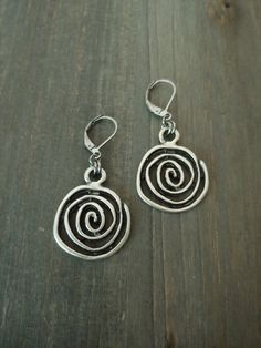 Bohemian Silver Spiral Earrings    These earrings are versatile and comfortable to wear. They will go with almost any outfit. They are great for gift giving or as a treat for yourself. 🌻 Measurements: The focal spiral charm is approximately 1 inch in diameter. The earring drop size/diameter is approximately 1.10 inch. (if choosing bean hooks, please see below.) The earring's total size (with the hooks included) is around 1.50 inch. With bean hooks: all the sizes will increase by 1 inch.  These earrings will be approximately 2 inches in total length with bean hooks. ⭐Colors may slightly vary due to the differences in screen monitor settings vs. real life lightings. Shipping:   I ship within 2 business (non-holiday) days of the purchase. The shipping service I use is First Class Package off Handmade Bohemian Swirl Earrings, Metal Spiral Earrings With Ear Wire, Spiral Metal Earrings With Ear Wire, Swirl Shaped Metal Earrings For Gift, Swirl Shaped Metal Earrings As Gift, Hypoallergenic Spiral Metal Earrings, Adjustable Spiral Metal Earrings, Metal Spiral Wrap Earrings, Metal Spiral Wrap Single Earring