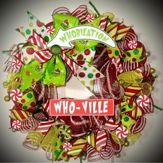 a wreath with candy canes and ribbons on it that says who - vule