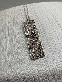 This vertical bar necklace has been entirely handmade using .999 fine silver. It has been cut out from fine silver precious metal clay, textured, fired and oxidized. The pendant hangs from a sterling silver diamond cut cable chain. This fine silver pendant features an embossed floral paisley textured pattern. Pendant size: approximately 1 1/4 x 3/8 inches Chain length: adjustable at 16 and 18 inches can also be customized to whatever length needed The necklace is sent in a gift box. This jewelry Layered Necklaces Boho, Moon Necklace Silver, Vertical Bar Necklace, Jewelry Holiday, Vertical Bar, Moon Gifts, Silver Bar Necklace, Layered Necklaces Silver, Precious Metal Clay