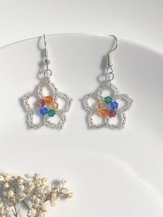 Rainbow earrings, beaded seed bead earrings, rainbow flower earrings, NHS, gifts for her,Floral earrings, Botanical  Garden inspired jewellery For that bright and beautiful look These are pretty little seed bead earrings with the rainbow crystal centre, cute, colourful sparkly and fun to wear. The five petals are made using silver lined seed beads which gives a little twinkle when it catches the light with movement. The centre crystal bi-cone glass beads are in red, orange, yellow, green and blu Multicolor Beaded Flower Earrings With Flower Charm, Multicolor Flower Shaped Beaded Earrings With Flower Charm, Multicolor Flower-shaped Beaded Earrings With Flower Charm, Colorful Beaded Flower-shaped Earrings, Flower-shaped Beaded Earrings With Bead Caps For Gifts, Silver Flower Beaded Earrings For Gift, Silver Flower Beaded Earrings As Gift, Handmade Silver Beaded Flower Earrings, Handmade Silver Flower Beaded Earrings