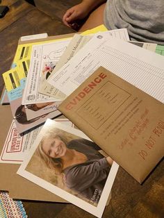 a pile of papers sitting on top of a wooden table