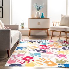 a living room with two chairs and a rug on the floor