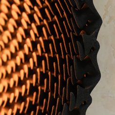 close up view of an orange and black pattern on the surface of a wall or ceiling