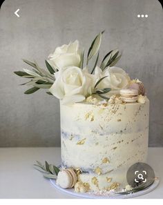 a white cake with flowers and seashells on top