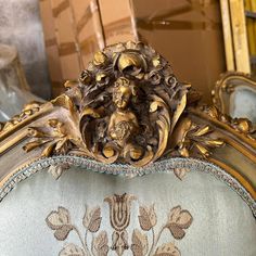 an ornately decorated gold and silver bed frame with flowers on it's sides