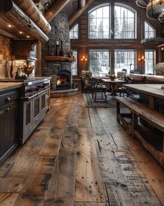 a large kitchen with wooden floors and an oven in the center is decorated with rustic decor