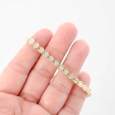 Featuring a total carat weight of 1.44. Crafted to perfection, this bracelet sparkles with every movement, making it a luxurious addition to any jewelry collection or a stunning gift for someone special. Bracelet length: 7"Bracelet width: 5 mmClosure style: Tennis claspMaterial: 14K Yellow GoldWeight: 13.9gDiamonds: 36 x 0.04Ctw = 1.44CtwColor And Clarity: G-H/SI1Total Carat Weight: 1.44Ctw For more of our jewelry products, please visit our shop 777jewelry Free shipping on all orders within the USA. International shipping available. We only sell real gold jewelry. We do not sell gold plated or gold filled jewelry. We offer a 30 day money back guaranteed return on all orders. Our goal is to make every customer satisfied. Luxury Diamond Tennis Bracelet With Channel Set, Luxury Diamond Channel Set Tennis Bracelet, Luxury Channel Set Diamond Tennis Bracelet, Fine Jewelry Diamond Bracelet With Channel Set, Channel Set Diamond Bracelet In Fine Jewelry Style, Fine Jewelry Diamond White Diamond Bracelet With Channel Set, Fine Jewelry Diamond Bracelets With Channel Set, White Gold Tennis Bracelet With Bezel Setting, Diamond White Channel Set Diamond Bracelet