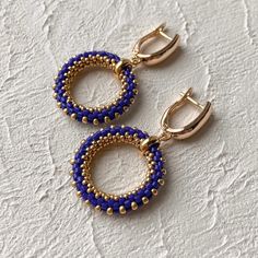 These navy blue and gold seed bead dangle earrings is a perfect gift for mom Earrings are made of high quality Japanese seed beads. Because of it's shape there is no space between each bead in work. Each jewelry looks like it's made of metal not of glass These earrings have gold plated latch back closure. It doesn't tarnish and causes no allergy Earrings are good for both girls and women. Wear it either for everyday use or for special occasions. It's minimalistic, elegant and sparkly * DETAILS * Blue Small Hoop Earrings With Matching Set, Blue Beaded Small Hoop Earrings, Handmade Blue Beaded Small Hoop Earrings, Handmade Blue Round Hoop Earrings, Blue Hoop Earrings For Gift, Handmade Blue Hoop Jewelry, Blue Earrings With Gold Beads, Blue Beaded Hoop Earrings Gift, Handmade Blue Beaded Hoop Earrings