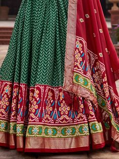 Introducing our stunning "attractive green patola printed silk function wear lehenga choli" that is sure to make you stand out at any festival or special occasion. This gorgeous ensemble features a green color tussar silk material lehenga with intricate foil work and patola print detailing, paired with a red color tussar silk choli also embellished with patola print work and foil work. Completing the look is a red color tussar silk dupatta with patola print work and tassels attached on both side Semi-stitched Green Choli For Eid, Semi-stitched Green Lehenga With Dupatta, Green Semi-stitched Lehenga With Dupatta, Festival Floor-length Anarkali Set With Motifs, Green Art Silk Lehenga With Zari Work, Semi-stitched Green Choli For Navratri, Green Art Silk Lehenga For Festive Occasions, Bollywood Style Green Art Silk Lehenga, Green Bollywood Art Silk Lehenga