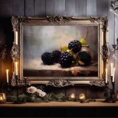 a painting on a mantle with candles and grapes