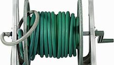 a green hose is connected to a metal stand