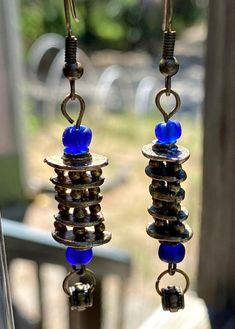 These earrings were made using vintage brass beads with a unique layer/tower design.  The brass balls between the layers allow light to penetrate.  I've added large blue glass seed beads for accent.  The earrings measure 2 ¼" long, 3/8" wide and ¼" in depth. The findings are brass. These are definitely some of my favorite earrings. Blue Beaded Brass Earrings, Blue Beaded Dangle Earrings In Brass, Blue Beaded Brass Dangle Earrings, Blue Dangle Beaded Brass Earrings, Blue Brass Beaded Dangle Earrings, Blue Beaded Brass Earrings With Ear Wire, Blue Brass Beaded Earrings With Ear Wire, Tower Design, Cedar Creek