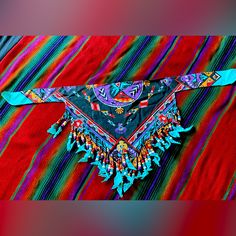 a colorful piece of cloth with fringes on it