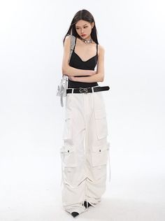 Add a fresh twist to your wardrobe with our white cargo pants. These pants offer both comfort and style, making them a versatile addition to any outfit. Model is 5'5 100lbs wearing S White High Waist Bottoms With Cargo Pockets, White High Waist Cargo Pants For Streetwear, High Waist White Bottoms With Cargo Pockets, High Waist White Cargo Pants For Streetwear, White High-waisted Bottoms With Cargo Pockets, Trendy White Pants With Side Pockets, White Parachute Pants With Multiple Pockets For Streetwear, Trendy White Pants With Pockets, White Full Length Pants With Belt Loops