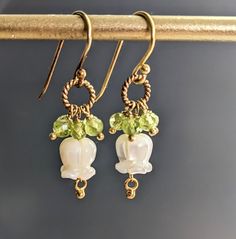 "Carved Mother of Pearl Tulip Flower and Peridot 24 K Gold Filled Wire Earrings, Gift For Her, June Birthstone  Earrings are 1 1/5\" ( 39 mm.) from top of the ear wire to the very bottom gold saucer bead.   Nice gift for her!  * Processing time is 3 - 5 days.  * US orders are shipped first class mail. * International orders are shipped first class international. * Shipping upgrades are available at checkout. Thank you for visiting my listing! Have a wonderful day!" Tulip Earrings, Birthstone Earrings, Tulip Flower, June Birthstone, Birthstone Earring, Tulips Flowers, Wire Earrings, June Birth Stone, Ear Wire