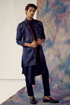 Space blue shawl collar hand embroidered jacket with wine detailing in floral motifs. Paired with matching draped kurta and tapered trousers.
Component: 3
Pattern: Embroidered
Type Of Work: Floral
Neckline: Jacket: Open
Sleeve Type: Kurta: Long
Fabric: Linen Silk
Color: Blue
Other Details: 
Embroidered jacket
Floral motifs
Occasion: Sangeet,Wedding - Aza Fashions Jatin Malik, Blue Shrug, Blue Shawl, Royal Look, Open Sleeve, Tapered Trousers, Indian Wedding Outfits, Floral Jacket, Embroidered Jacket