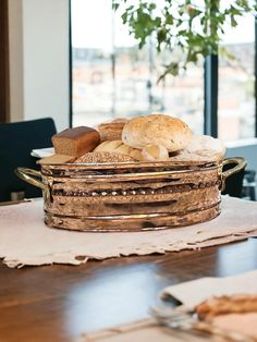 bread in a basket on top of a wooden table