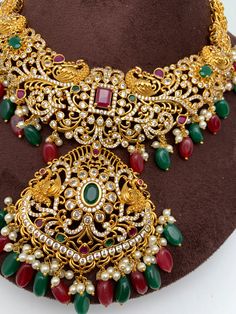 Red Green Stone Peacock Red Green beads Ethnic Necklace with Matching Screwback EarringsColor : GoldenSize : Necklace Length : 16 Inches; Earring Length : 2.5 InchesStones : Red Green Stone CZ pearls Red Green Beads Traditional Festival Earrings With Stones, Traditional Red Jewelry Sets With Stones, Red Bohemian Kundan Necklace For Diwali, Traditional Bridal Necklace With Stones For Festivals, Red Peacock Design Necklace As A Gift, Red Peacock Design Necklace As Gift, Red Kundan Jewelry With Peacock Design, Multicolor Peacock Design Temple Jewelry Sets, Red Peacock Design Temple Jewelry Necklace