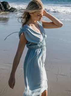 Ethereal and the color of blue skies and lapping waves. Our Goddess dress is light and airy with drawstring shoulder and ruched elastic empire waist detailing. 100% cotton deadstock cotton voile One Size S/M Chest width flat 18" Empire elastic waist flat 13", stretches to 19" Hip width flat 24" Body length from shoulder 42" Fully lined Hand wash cold, line dry, or dry clean Consciously made in small batches in sunny California using deadstock fabrics and recycled materials. Seasonless essentials Summer Cotton Midi Dress With Gathered Waist, Summer Maxi Dress With Drawstring, Cotton Summer Dresses With Gathered Neckline, Summer Midi Dress With Gathered Waist For Daywear, Summer Cotton Dresses With Gathered Neckline, Summer Vacation Maxi Dress With Drawstring, Beach Midi Dress With Gathered Waist In Cotton, Flowy Maxi Dress With Drawstring, Flowy Drawstring Maxi Dress