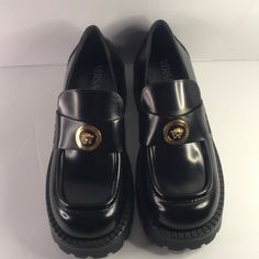 New Versace Medusa Lug Sole Penny Loafer One Look At The Gilded 'Medusa' Head Sitting Atop The Wide Penny Strap On These Loafers, And Any Fan Will Know They're Versace's. They're Made From Black Glossed-Leather And Set On Chunky Rubber Lug Soles Fits Small To Size, Take A Half Size Larger Than Normal Narrow At The Top Of The Foot Italian Sizing Without Box Heel Measures Approximately 35mm/ 1.5 Inches With A 15mm/ 0.5 Inch Platform Black Glossed-Leather (Calf) Slip On Small To Size. See Size & Fi Designer Slip-ons With Rubber Sole And Round Toe, Luxury Brogue Detailing Closed Toe Loafers, Luxury Black Slip-ons With Round Toe, Luxury Black Moccasins, Platform Patent Leather Loafers With Round Toe, Designer Round Toe Moccasins For Work, Luxury Slip-ons With Brogue Detailing And Round Toe, Luxury Brogue Detailed Slip-ons With Round Toe, Luxury Slip-ons With Brogue Detailing