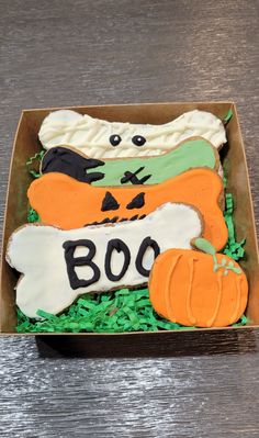 a decorated halloween cookie in a box on a table