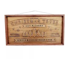 a wooden sign that says christmas trees cut and carry