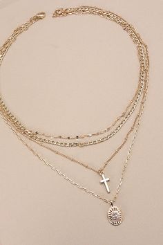 Multi-Layer Cross Oval Charm Necklace, a striking blend of faith and style, perfect for expression. This necklace features multiple layers adorned with intricately designed cross and oval charms, creating a captivating and meaningful accessory. Crafted with meticulous attention to detail and quality, each layer adds depth and dimension to the design, making it a versatile piece that complements any ensemble. Product Details:length: 16", 17", 18", 19"charm: .75"ext: 3" Ball Chain Extclasp: Lobste Layer Oval, Stacking Necklaces, Layered Crosses, Necklace Layered, Stacked Necklaces, Gold Cross Necklace, Gold Necklace Layered, Gold Rhinestone, Oval Pendant