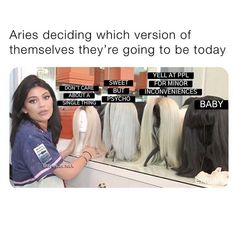 a woman standing in front of a display of wigs