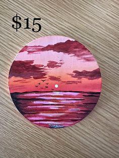 a pink and purple sunset painted on a wooden surface with the price $ 15 5