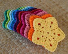 small crocheted coasters are arranged on a woven surface