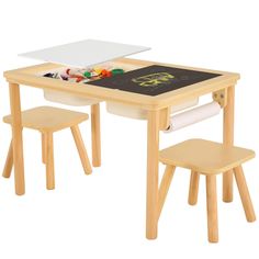 a wooden table with two chairs and a chalkboard on it