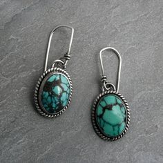 "Ovals of matrixed turquoise framed in sterling silver. One of a kind turquoise Earrings.   Striking abstract matrix turquoise cabochons set in solid sterling silver.   Handmade sterling silver French ear wires. Total length from the top of the ear wires to the bottom of the earrings is 1 1/4 inches. Turquoise cabochons are  5/8\" x 1/2\". One of a kind, ready to ship. You may also like: https://www.etsy.com/shop/KiraFerrer For more turquoise: https://www.etsy.com/shop/KiraFerrer?ref=hdr_shop_me Southwestern Oval Earrings As Gift, Southwestern Oval Earrings For Gift, Bohemian Oval Cabochon Earrings, Sterling Silver Turquoise Cabochon Earrings, Bohemian Turquoise Oval Earrings, Handmade Oval Turquoise Earrings, Nickel-free Oval Turquoise Earrings, Turquoise Frame, Sterling Silver Turquoise Earrings