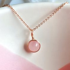 This beautifully simple necklace is lovingly handmade with Rose Quartz pendant and a choice of 14k Gold Filled, 14k rose Gold Filler or Sterling Silver chain. M A T E R I A L S: * Rose Quartz * 14k Gold Filled, 14k Rose Gold Filled, Sterling Silver S I Z E: *  Pendant - Approximately 6mm *  Chain Thickness - Approximately 1.1mm  All of our jewellery is carefully handmade using good quality materials and handpicked gemstones, with the aim to produce quality pieces that you can love & wear for years to come.  R O S E  Q U A R T Z: * Alternate Birthstone of January * Talisman for Taurus & Libra * Heart Chakra Rose Quartz is the stone of universal love.  It restores trust and harmony in relationships, encouraging unconditional love.  Rose Quartz purifies and opens the heart at all levels to pr Tiny Pendant Necklace, Rose Quartz Wedding, Rose Quartz Pendant Necklace, Pink Gemstone Necklace, Rose Quartz Necklace Pendants, Opalite Necklace, Dainty Rose, Tiny Pendant, Quartz Pendant Necklace