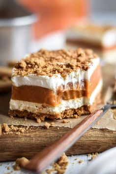 a piece of dessert sitting on top of a wooden cutting board