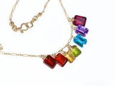 Rainbow station necklace made in 14K Solid Gold with exquisite diamond cut colorful natural gemstones. Click to discover more details! Multicolor Gemstones For Gifts, Multicolor Gemstones As A Gift, Fine Jewelry With Multicolor Briolette Gemstones, Multicolor Briolette Gemstones Fine Jewelry, Rainbow Multi-stone Necklace In Fine Jewelry Style, Elegant Rainbow Faceted Jewelry, Rainbow Multi-stone Briolette Jewelry, Multicolor Gemstone Accent Fine Jewelry Necklaces, Elegant Rainbow Necklace With Gemstone Accents