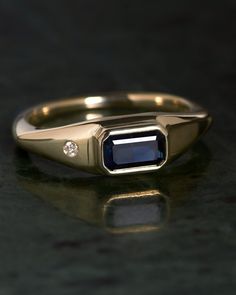 a gold ring with a blue stone in the center