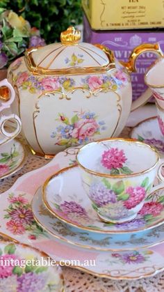 an assortment of tea cups and saucers on a table