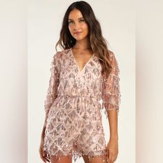 Nwt Lulu’s Xs Rose Gold Romper The Lulus Sweet Sparkles Rose Gold Sequin Fringe Embroidered Romper Is Glamorous And Fun, All Wrapped Up In One Pretty Package! Fringe-Y Strands Of Rose Gold Sequins And A Subtle Embroidered Diamond Pattern Accent Sheer Mesh As It Shapes This Cute Romper With A Surplice Neckline And Dolman-Style Half Sleeves. A Blousy Bodice Tops An Elasticized Waist And Loose-Fitting Shorts. Keyhole Opening And Button Closure At Back. Lined. Shell: 100% Polyester. Lining: 100% Pol Pink Sequined Jumpsuits And Rompers For Summer, Pink Sequined Jumpsuits And Rompers For Party Season, Embroidered Jumpsuits And Rompers For Summer Parties, Fitted Jumpsuits And Rompers For Festive Summer, Fitted Jumpsuits And Rompers For Summer Festivals, Summer Festive Sequined Jumpsuits And Rompers, White Long Sleeve Romper, Gold Romper, Black Halter Jumpsuit