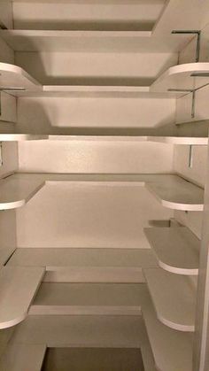 an empty white closet with shelves and no one in the room or someone else is there