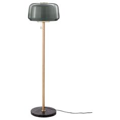 a floor lamp with a wooden base and a grey lampshade on the top